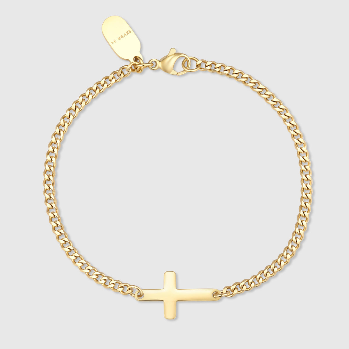 Gold cross bracelet with a small cross charm and linked chain
