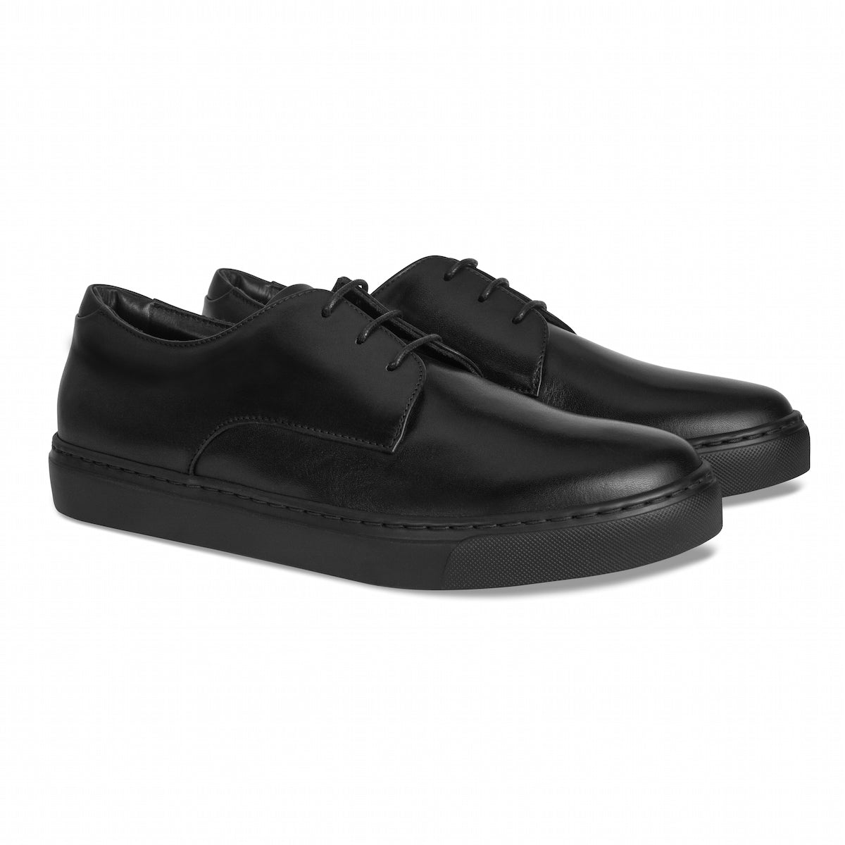 Black lace-up oxfords shown in side angle with textured sole and stitched panels.