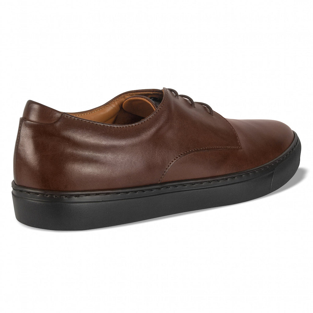 Brown leather lace-up dress shoe rear view with cushioned collar and dark sole