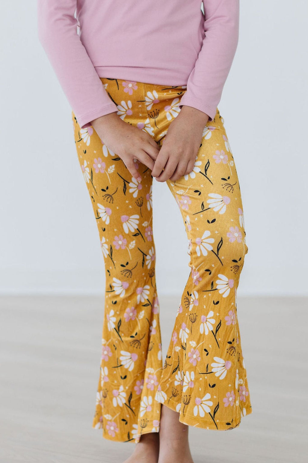 Mustard yellow floral bell-bottom pants with ribbed velvet waistband