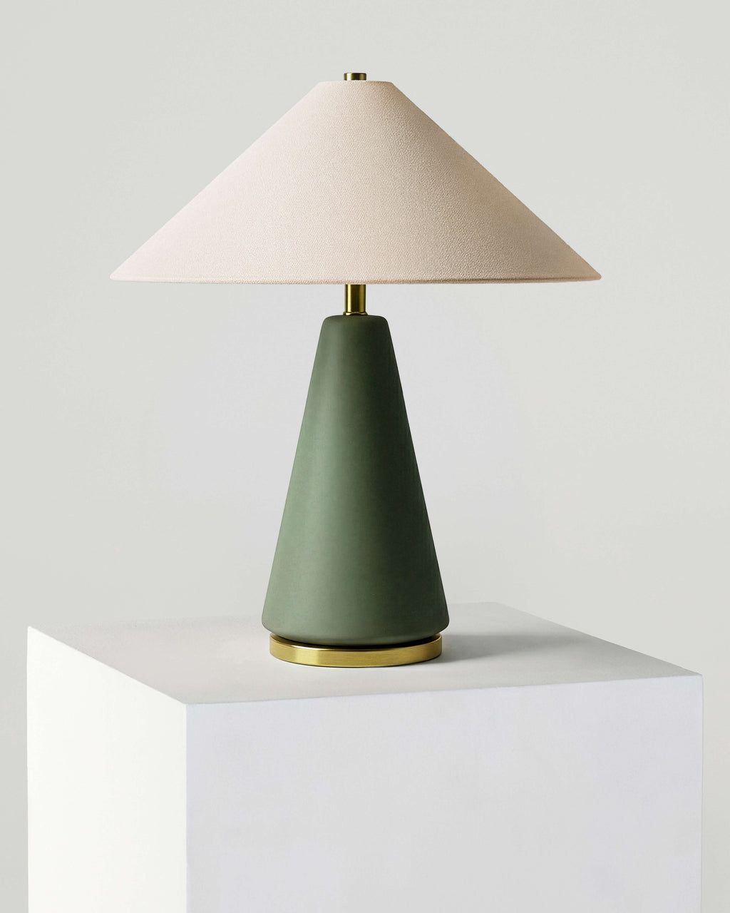 Table lamp with white fabric shade and olive green base, brass accents, standalone