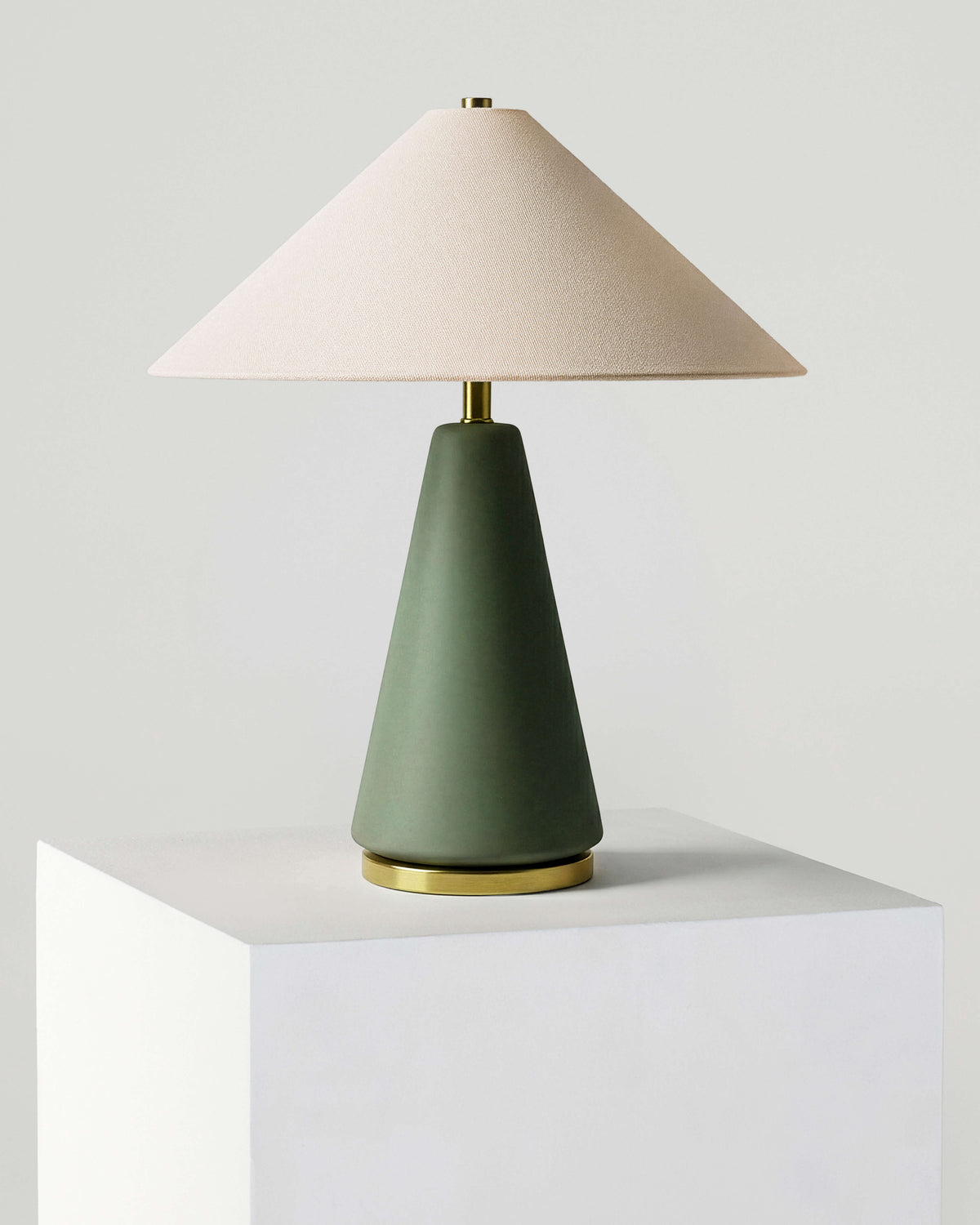 Table lamp with white fabric shade and olive green base, brass accents, standalone