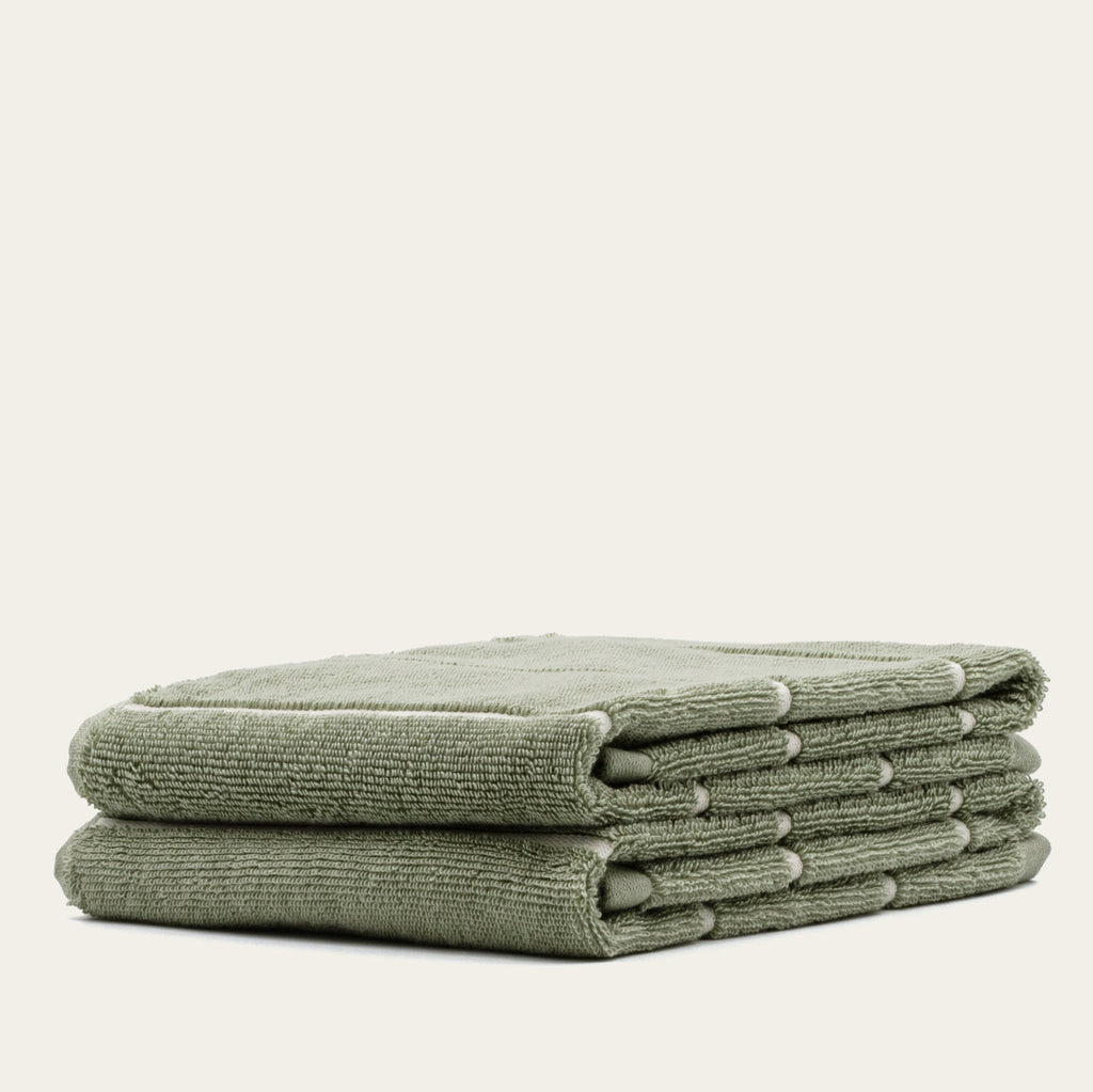 Sage green cotton towels, folded stack of four