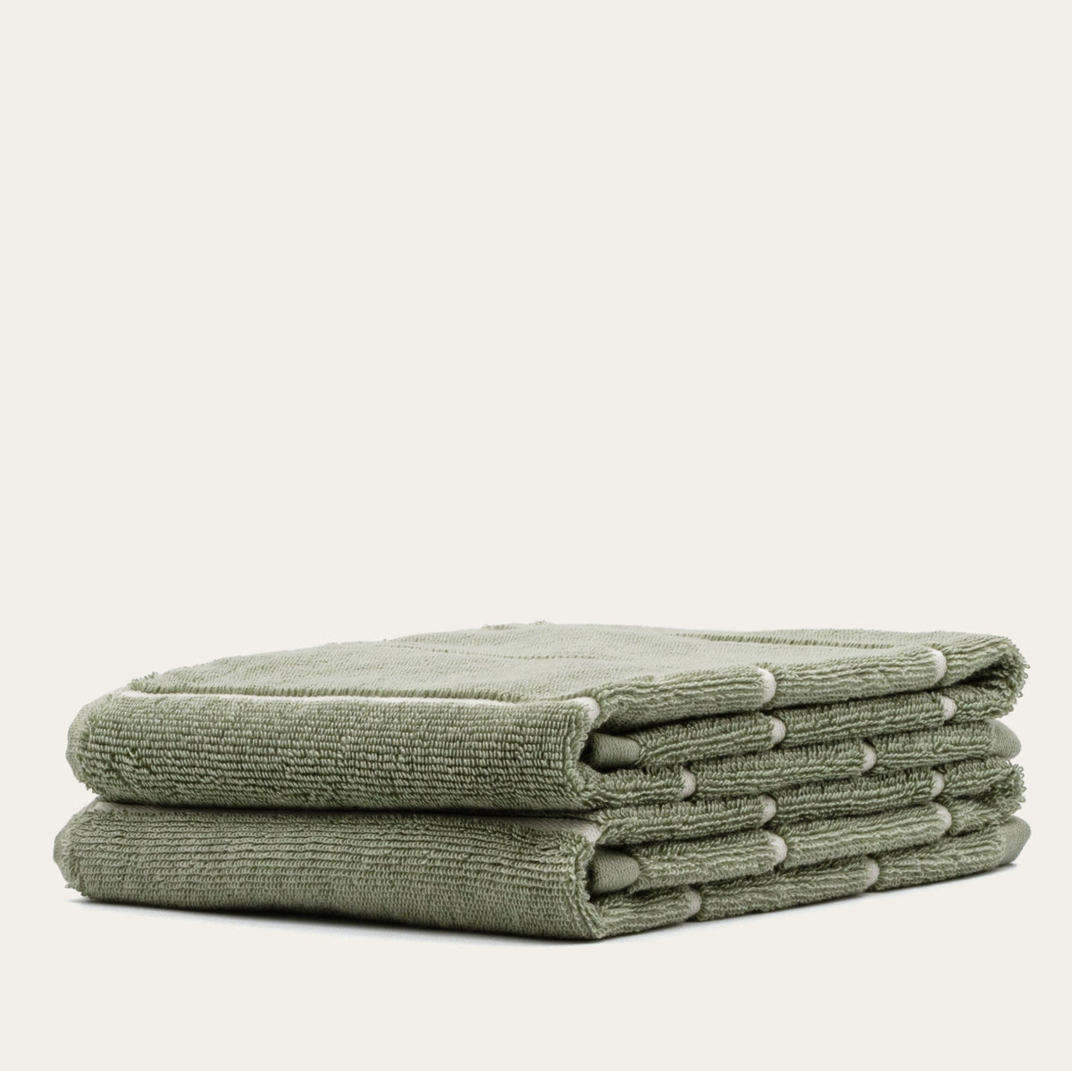 Sage green cotton towels, folded stack of four