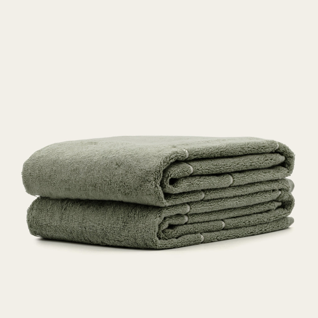 Sage green cotton towels, folded stack of three