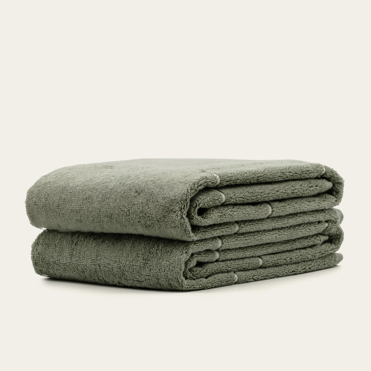 Sage green cotton towels, folded stack of three