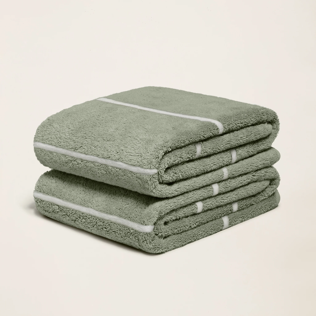 Sage green cotton towels with white stripe ties, folded stack of three