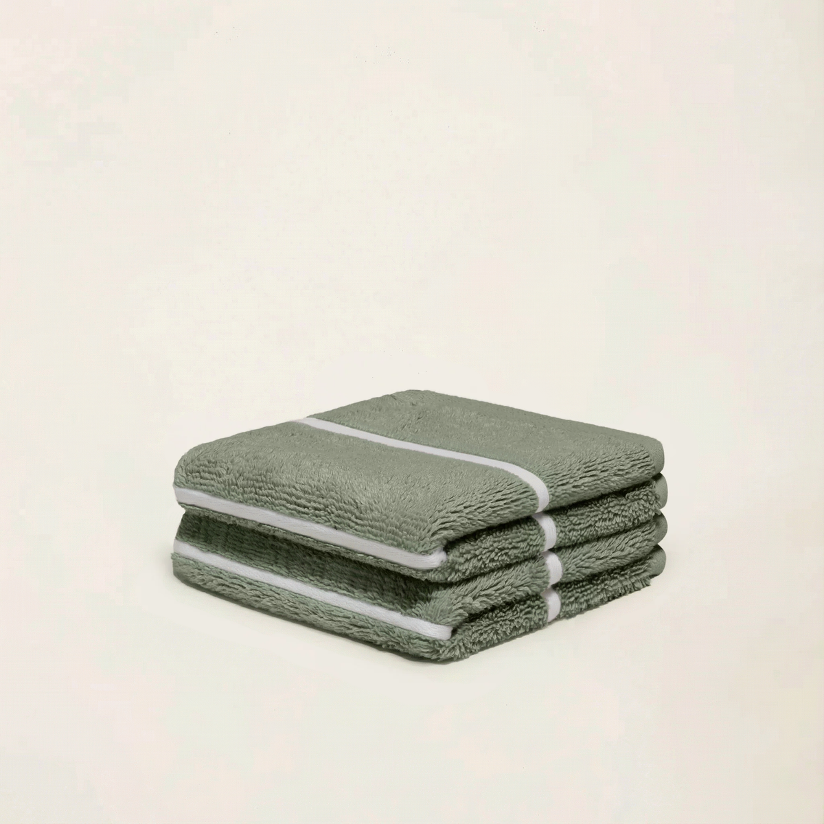 Sage green cotton towels with white stripe, folded stack of three