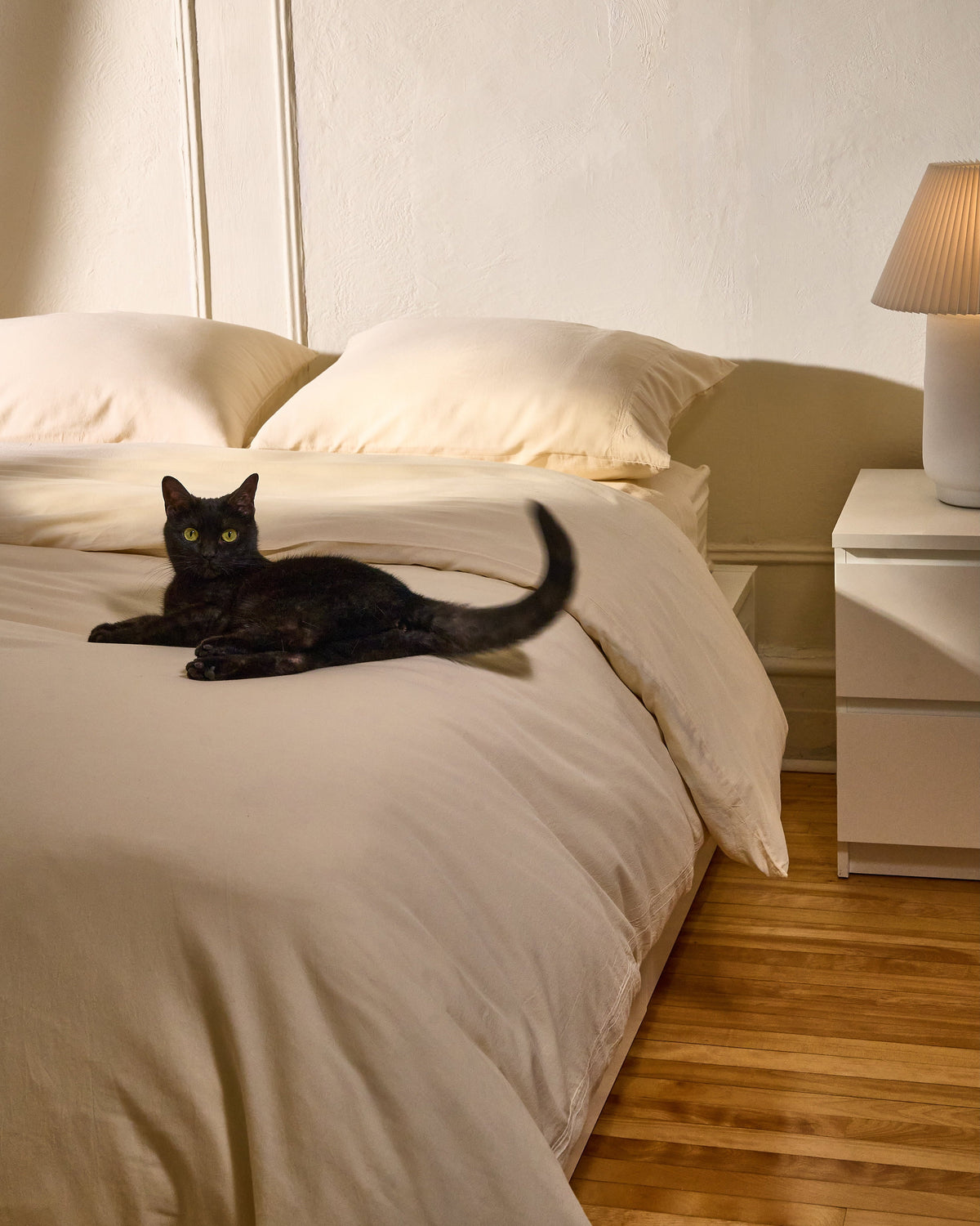 Cream milk-fibre pillowcase set on bed, two pillowcases and duvet visible