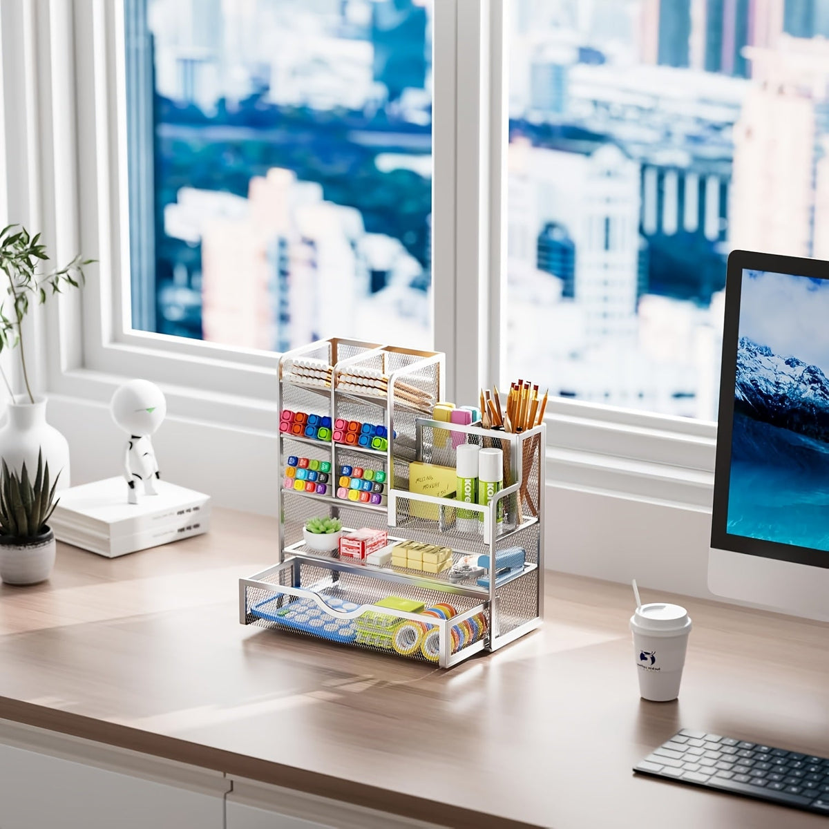 Small iron mesh desk organizer in light color with stacked trays for pens and supplies