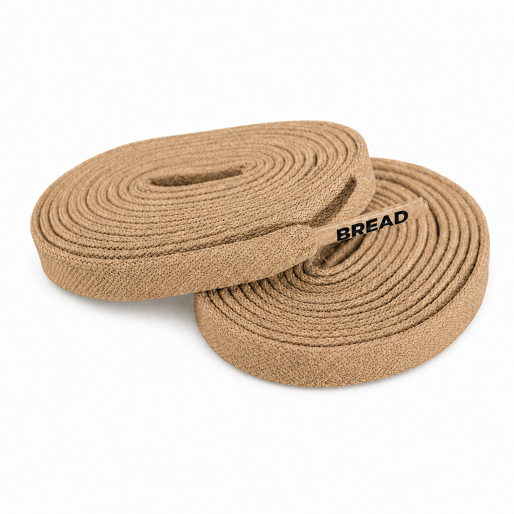 Desert tan elastic shoelaces, coiled bundle with BREAD logo.