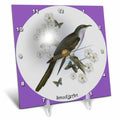 Desk clock with circular white dial, green bird and butterflies, purple border