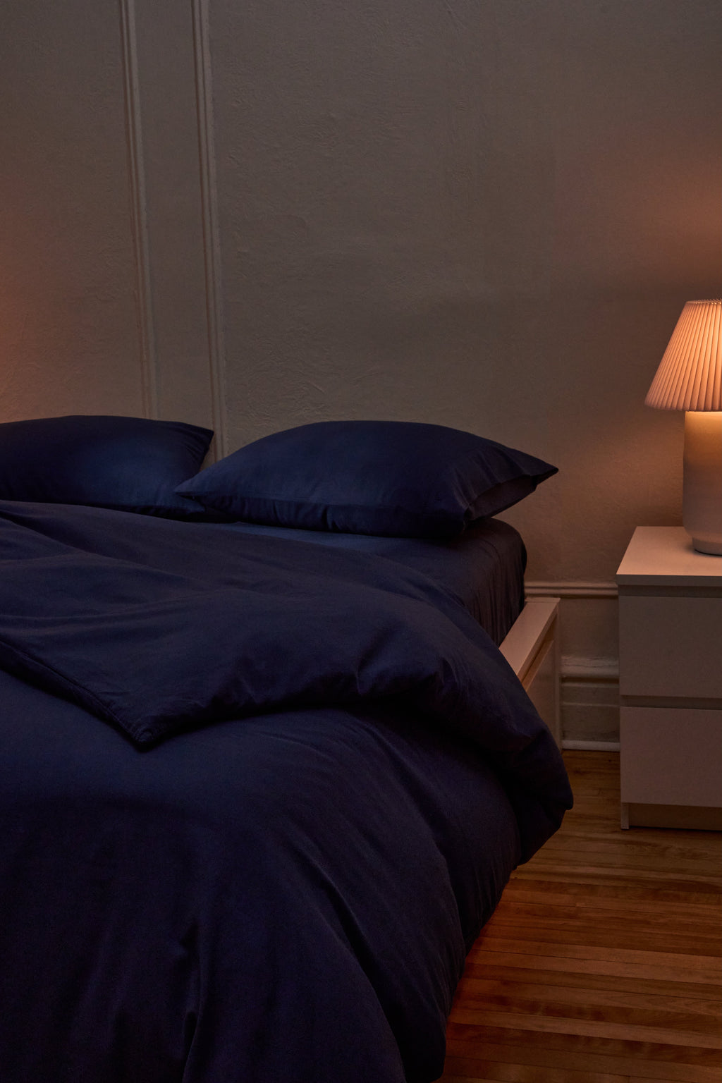 Navy duvet cover with pillowcases on a bed