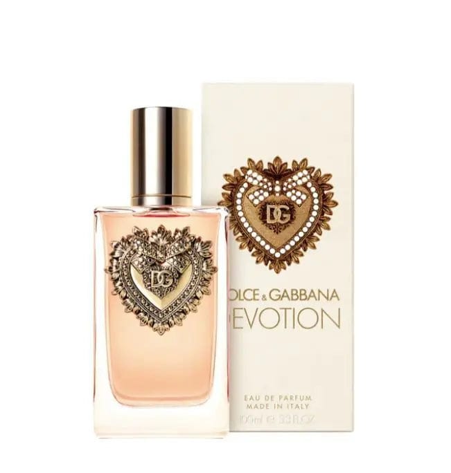 Women’s Eau de Parfum bottle with gold cap and ornate heart logo on pink glass