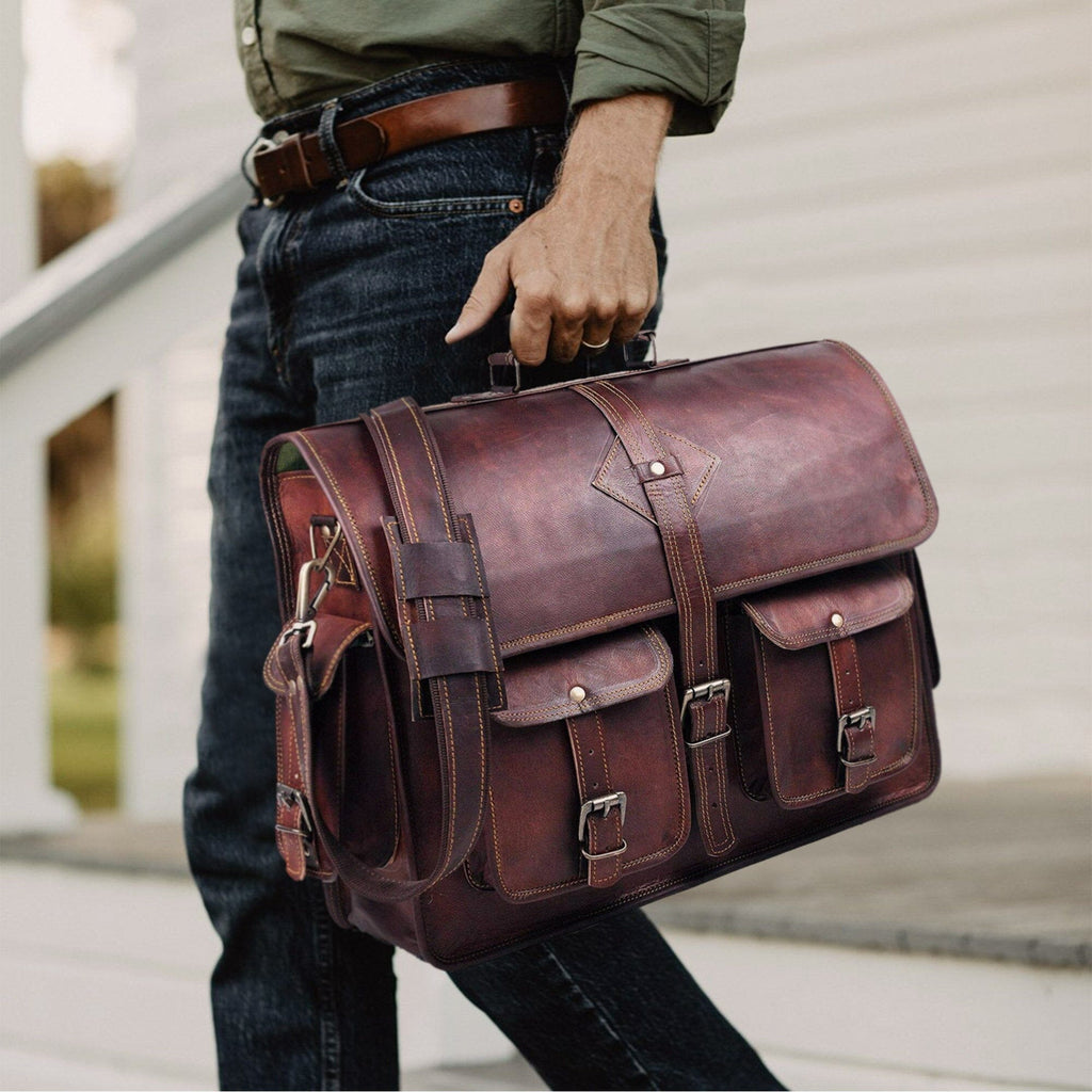 Brown leather messenger briefcase with flap closure and shoulder strap on the person