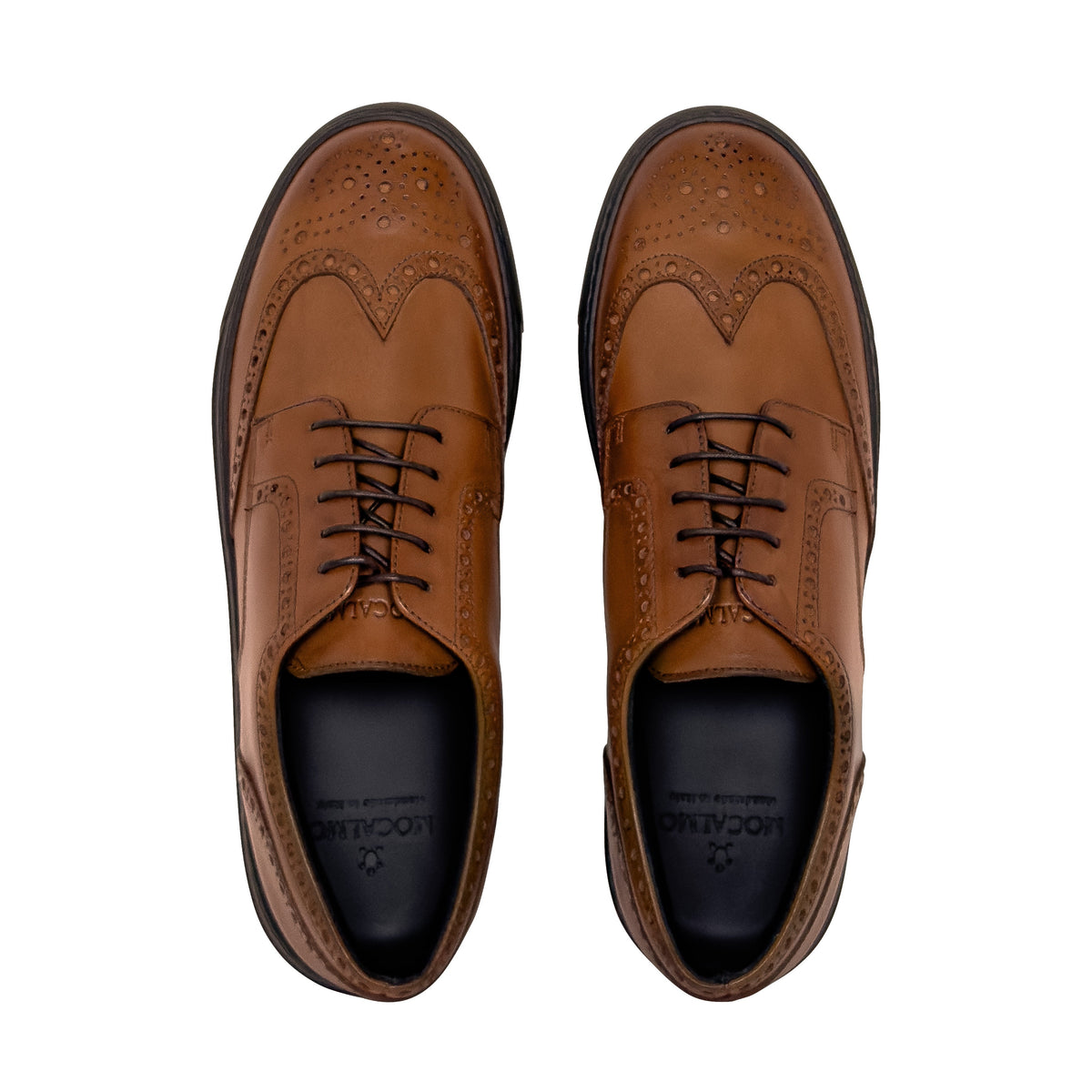 Pair of cognac wingtip oxford shoes with lace-up front and black interior