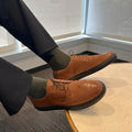 Cognac lace-up wingtip oxford shoes with black soles