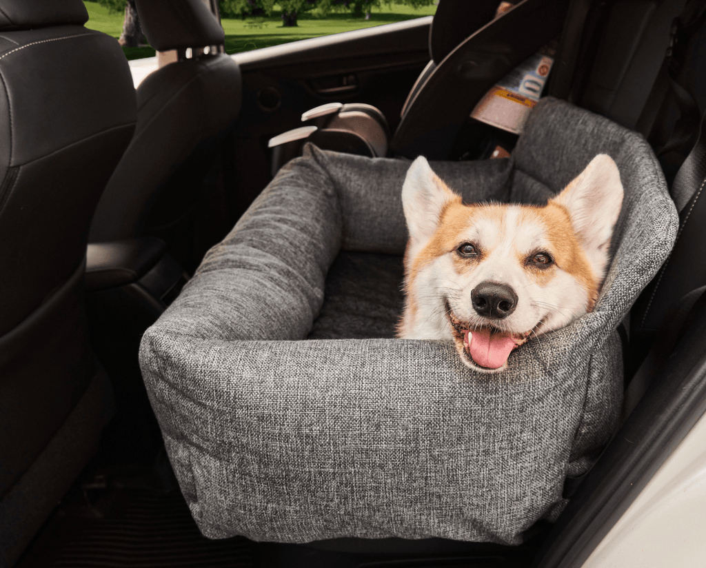 Gray tweed memory foam dog car bed with dog resting inside the car