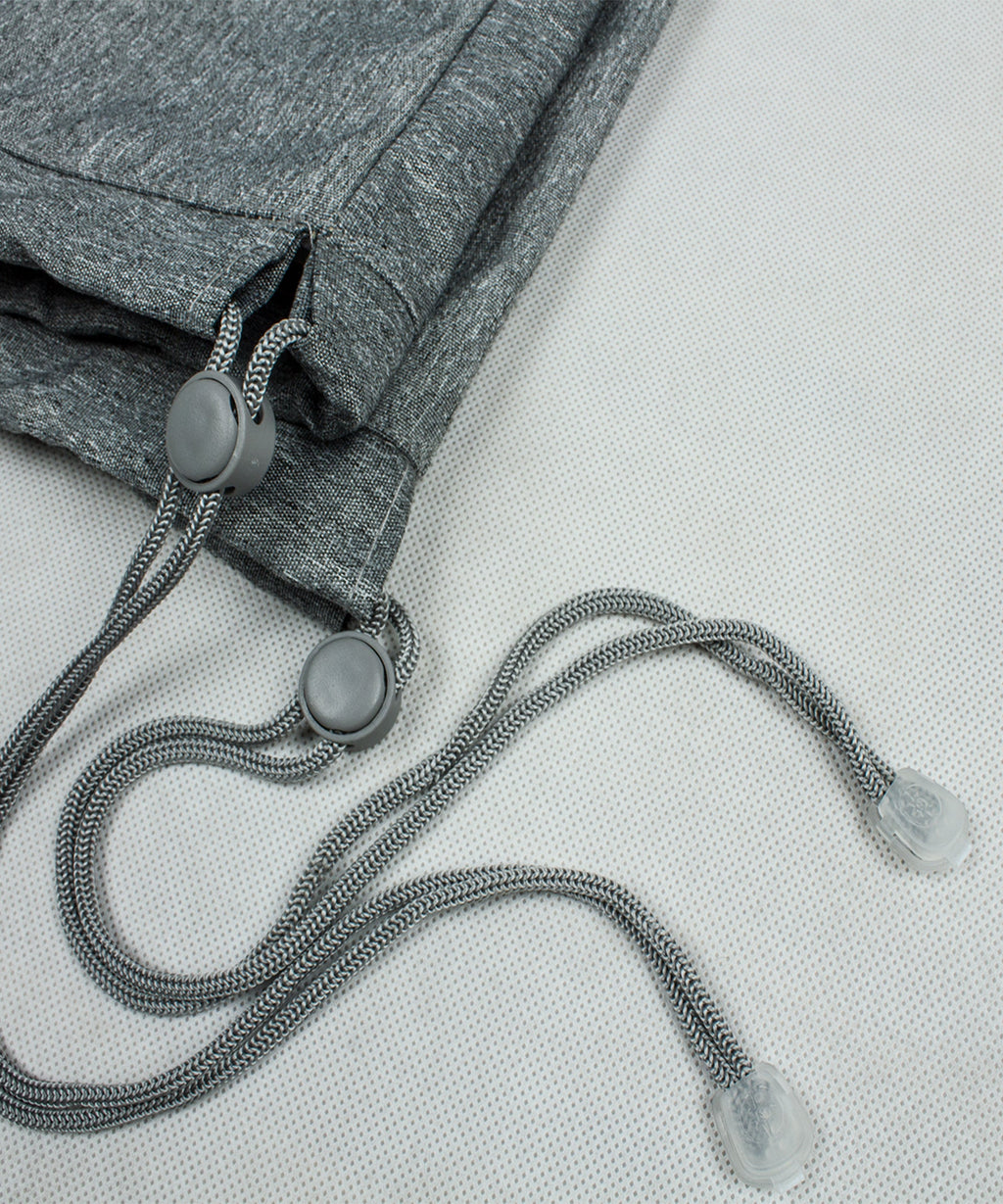 Gray tie cord with metal grommet and toggle for tightening the cover