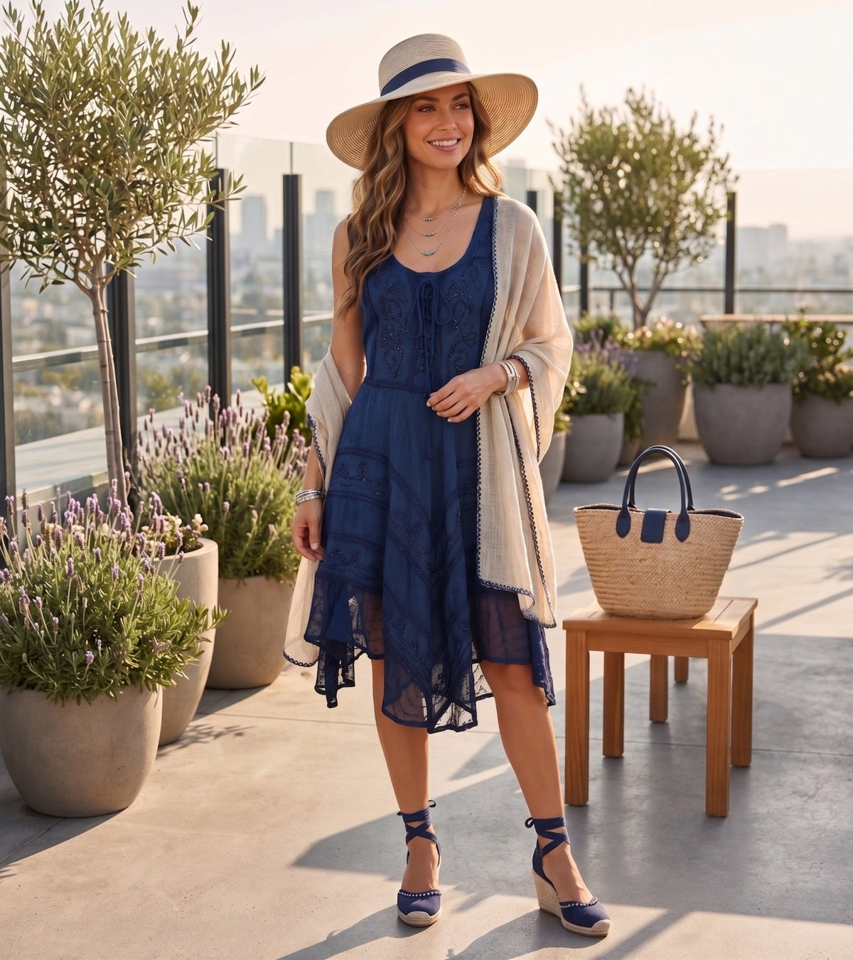 Sleeveless navy mid-length dress with embroidered bodice and lace-trim at hem