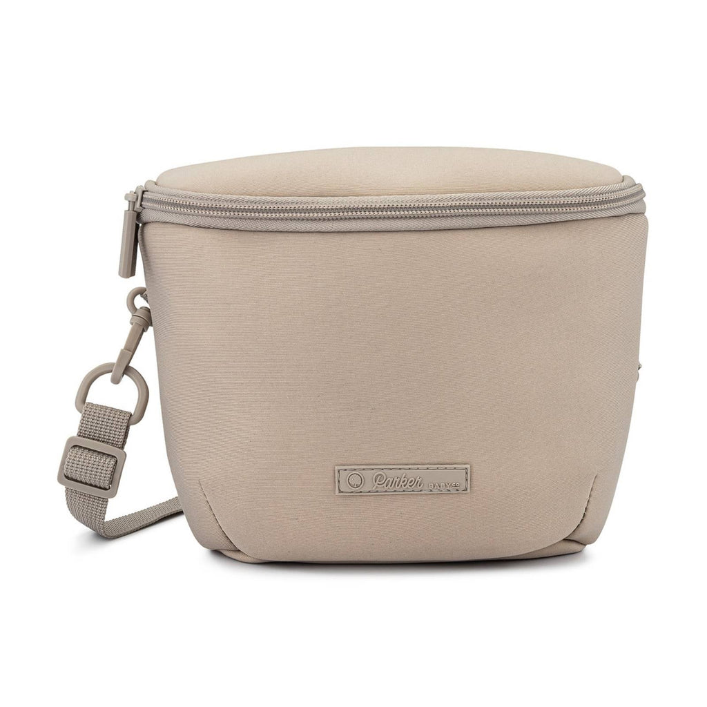 Beige neoprene diaper backpack with front zip, crossbody strap, and logo label