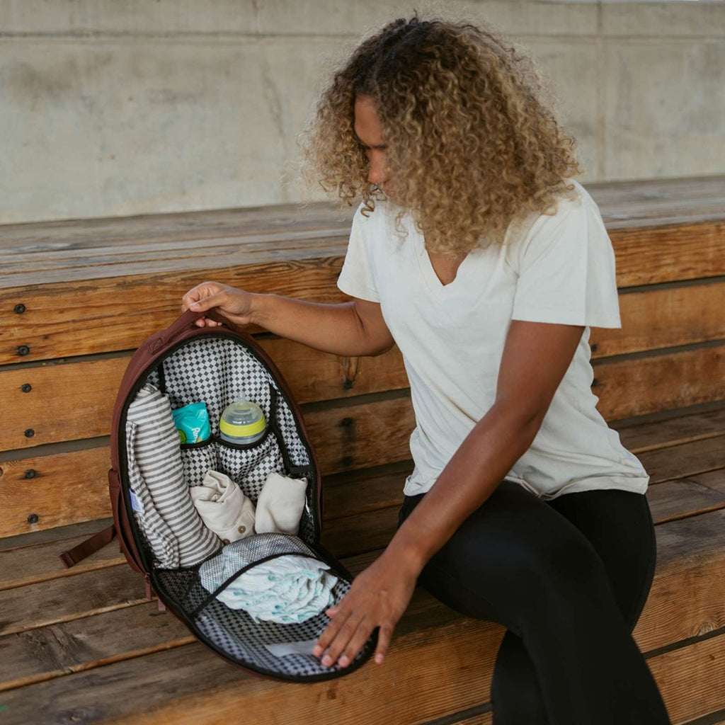 Raisin brown neoprene diaper backpack, open with baby essentials inside