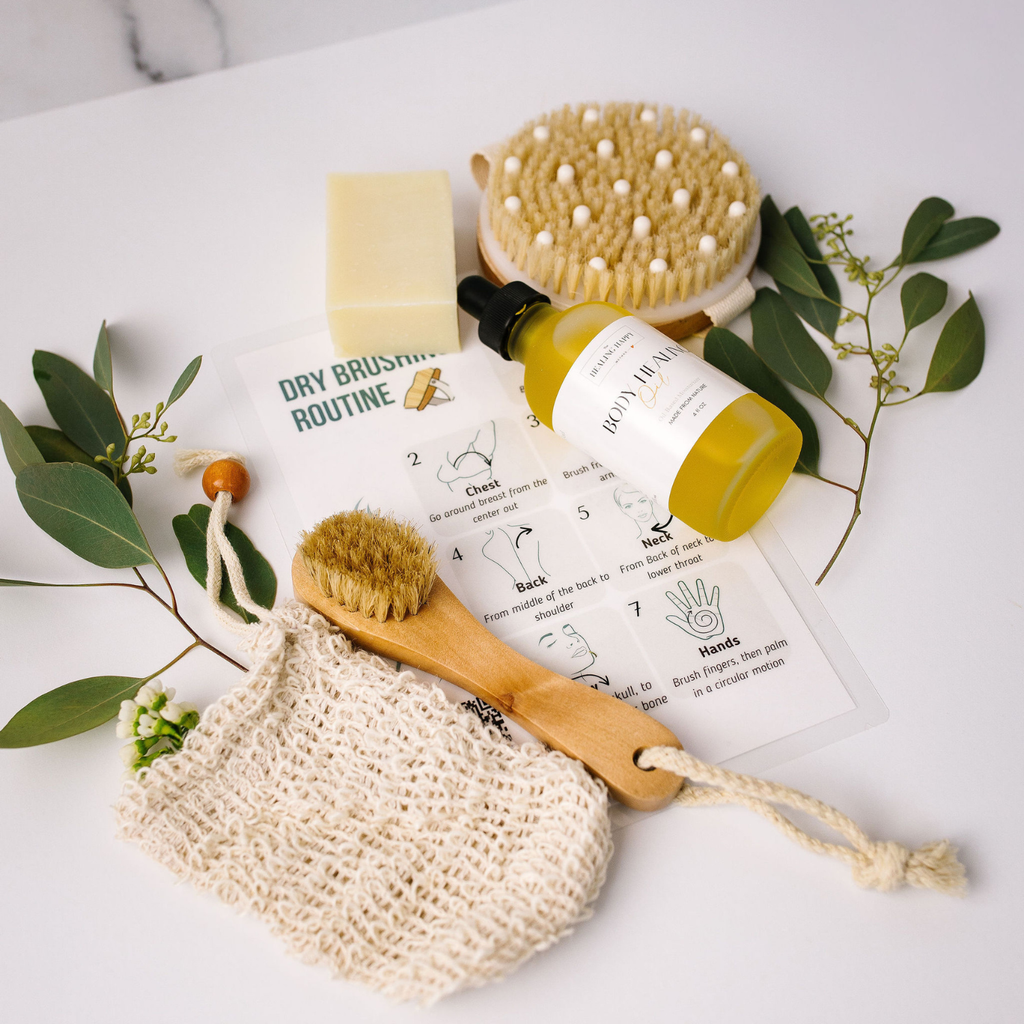 Dry skin kit with wooden brush head, yellow oil bottle, soap bar, exfoliating mesh pouch