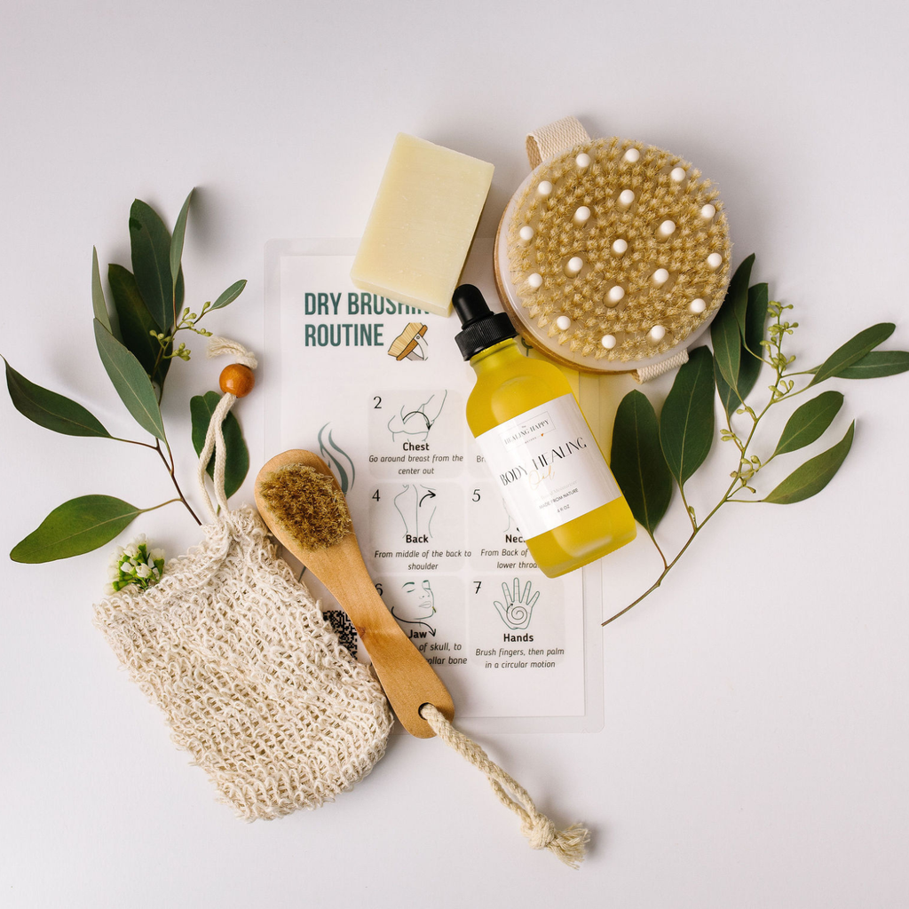Body care kit with round wooden brush, yellow oil, soap bar, and dry-brushing guide