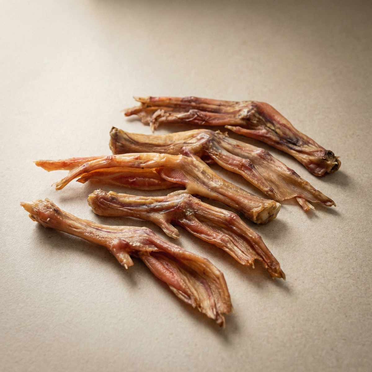 Dried duck feet dog treats arranged on a flat surface
