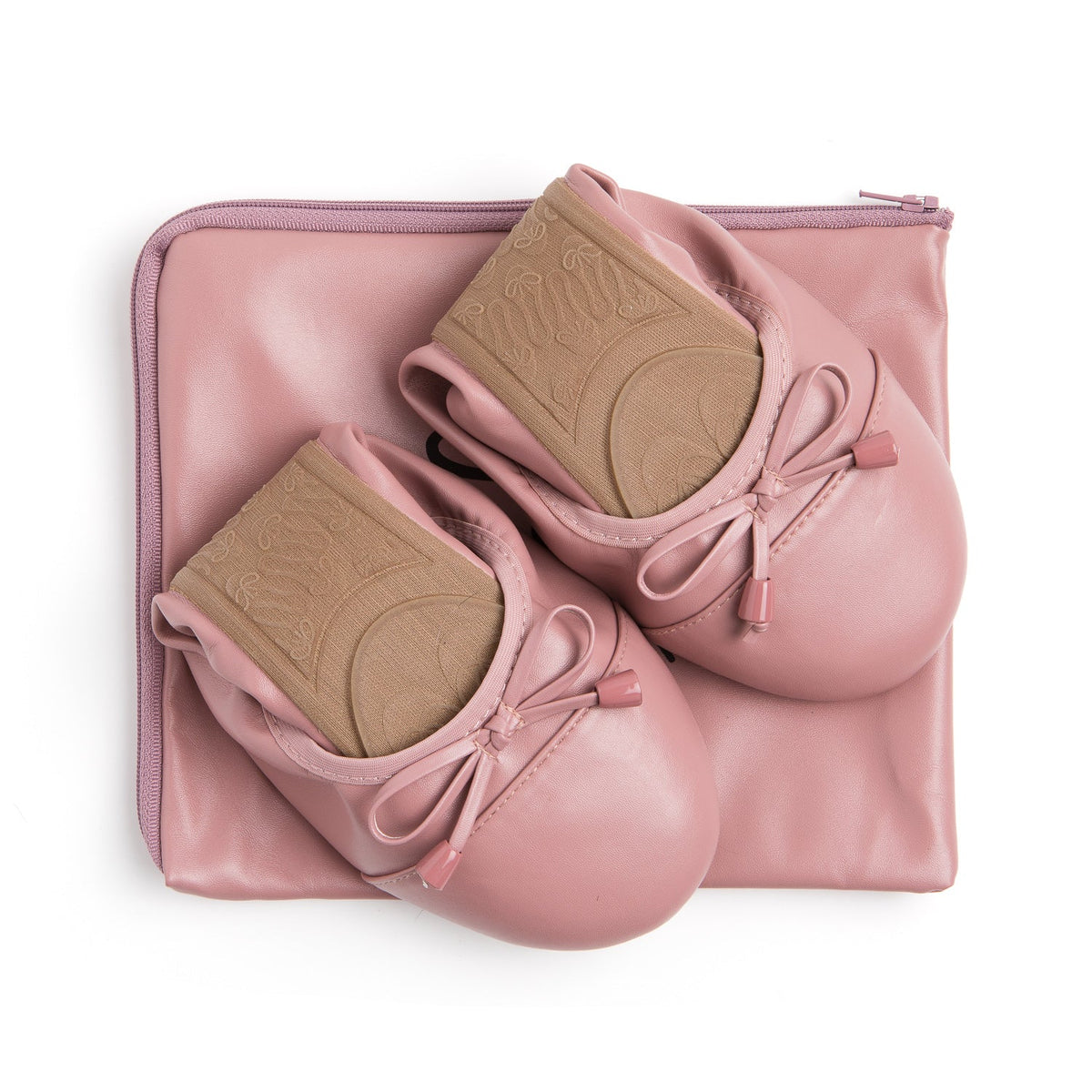 Pair of dusty rose flats with bow ties and embossed tan footbed