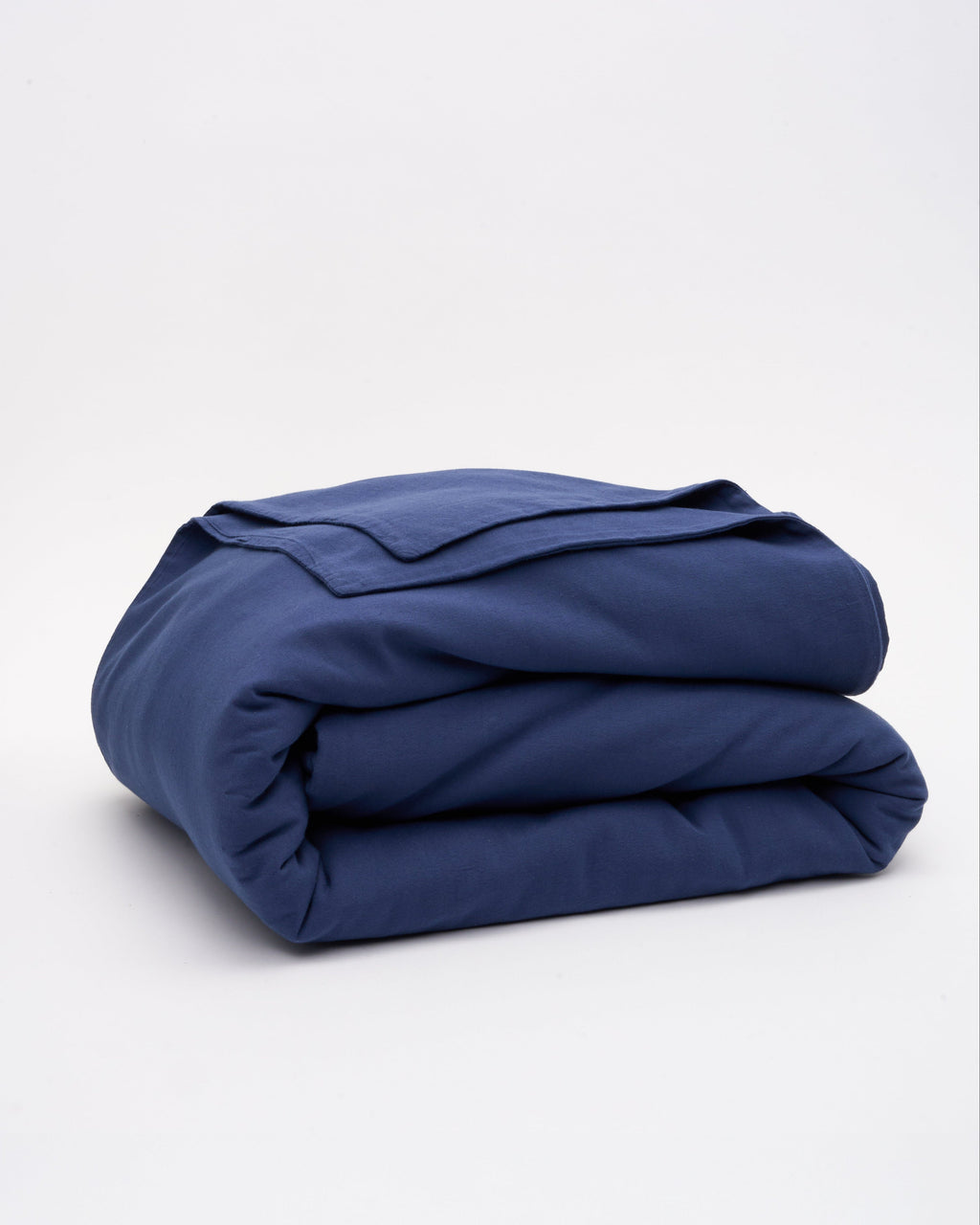 Folded blue duvet cover with matching fabric layers