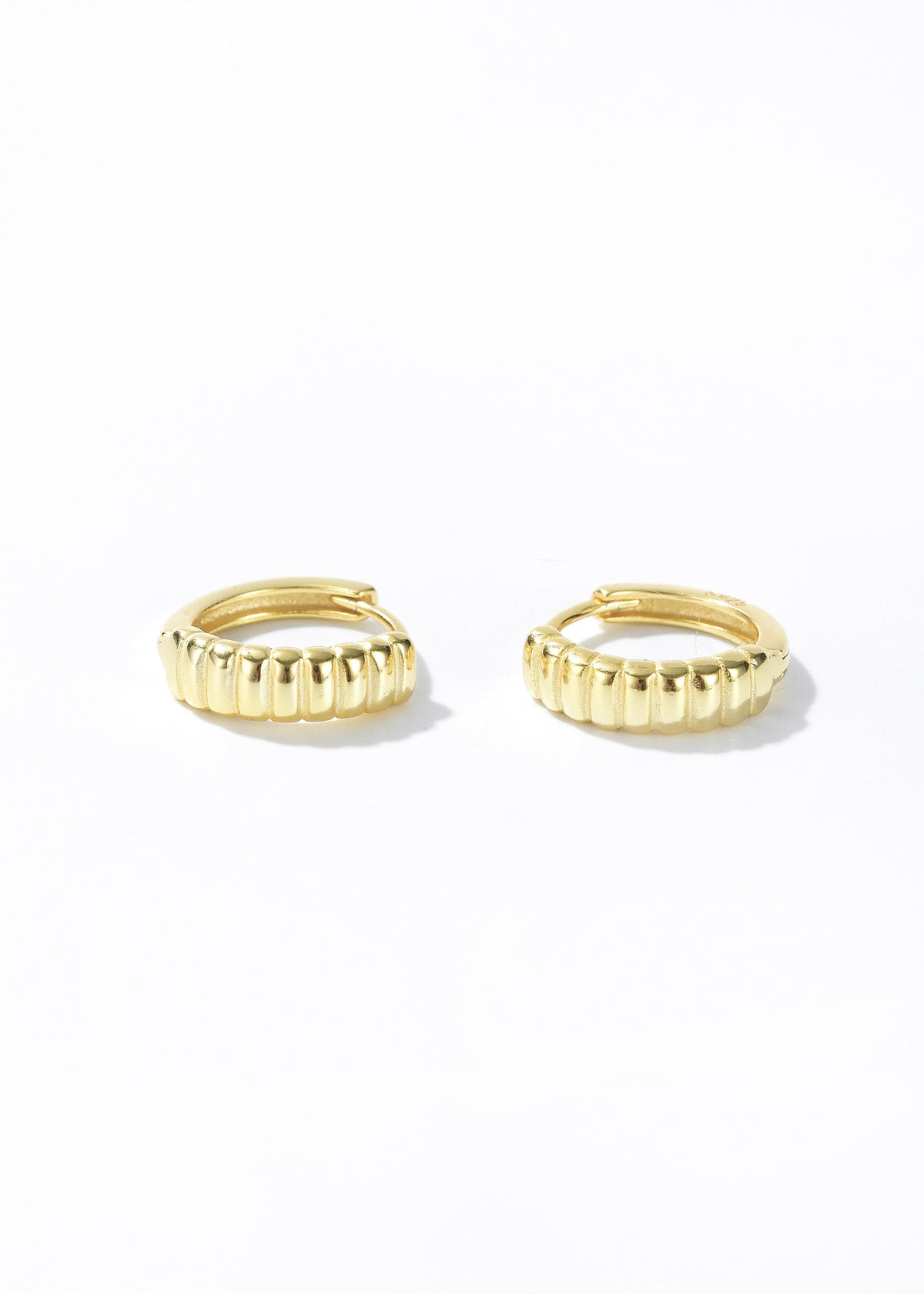 Gold retro hoop earrings with ridged vertical texture along the band