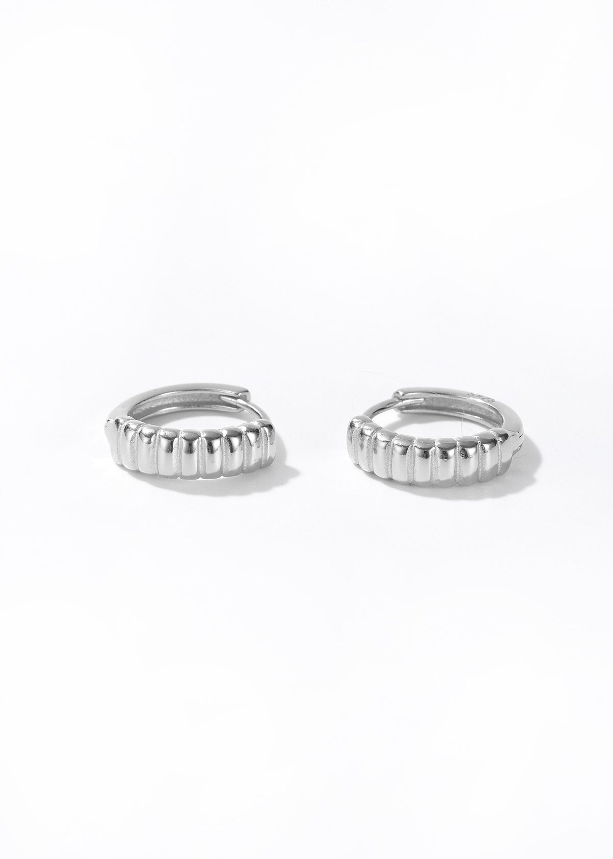 Silver retro hoop earrings with ridged vertical texture along the band