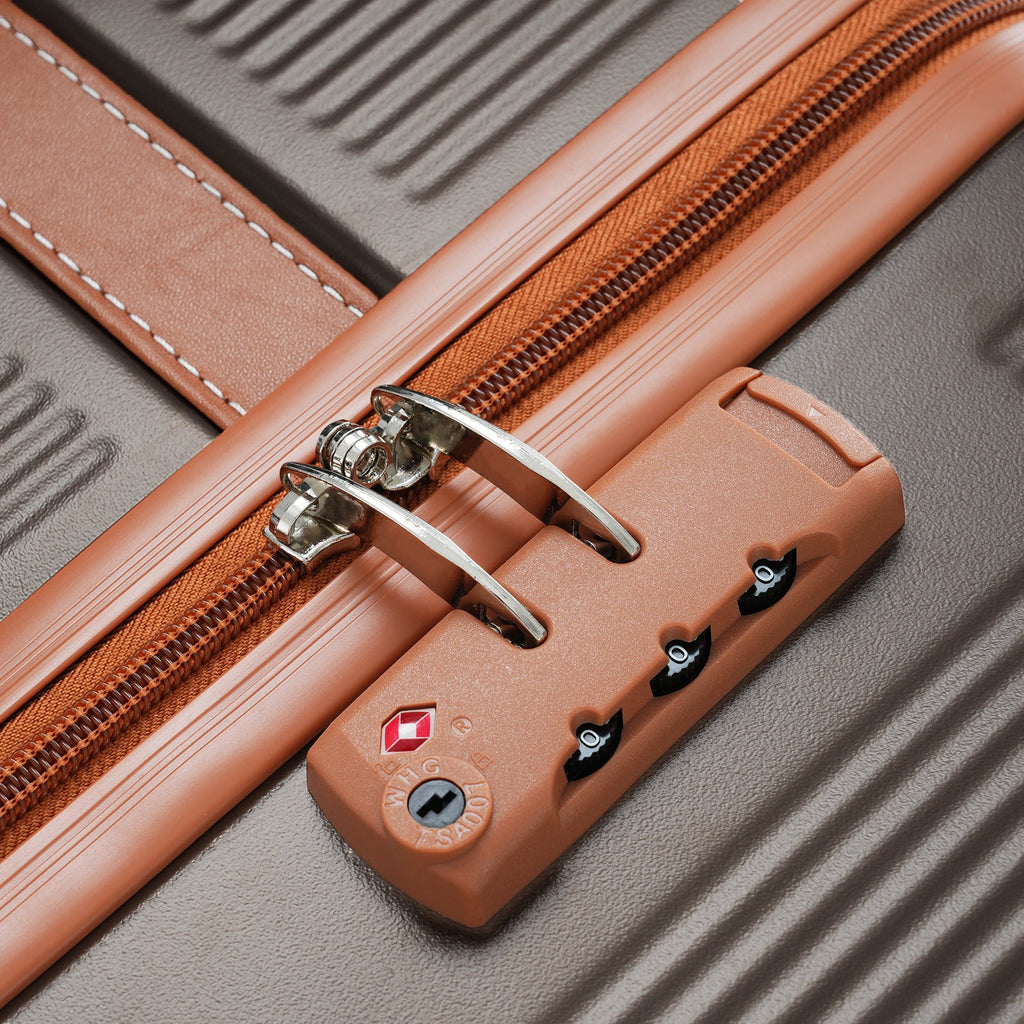 Close-up of copper trim zipper and TSA lock dials on hardshell case