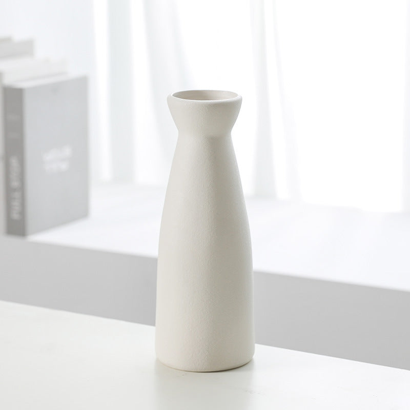 White ceramic vase bottle with rounded shoulders and small circular opening