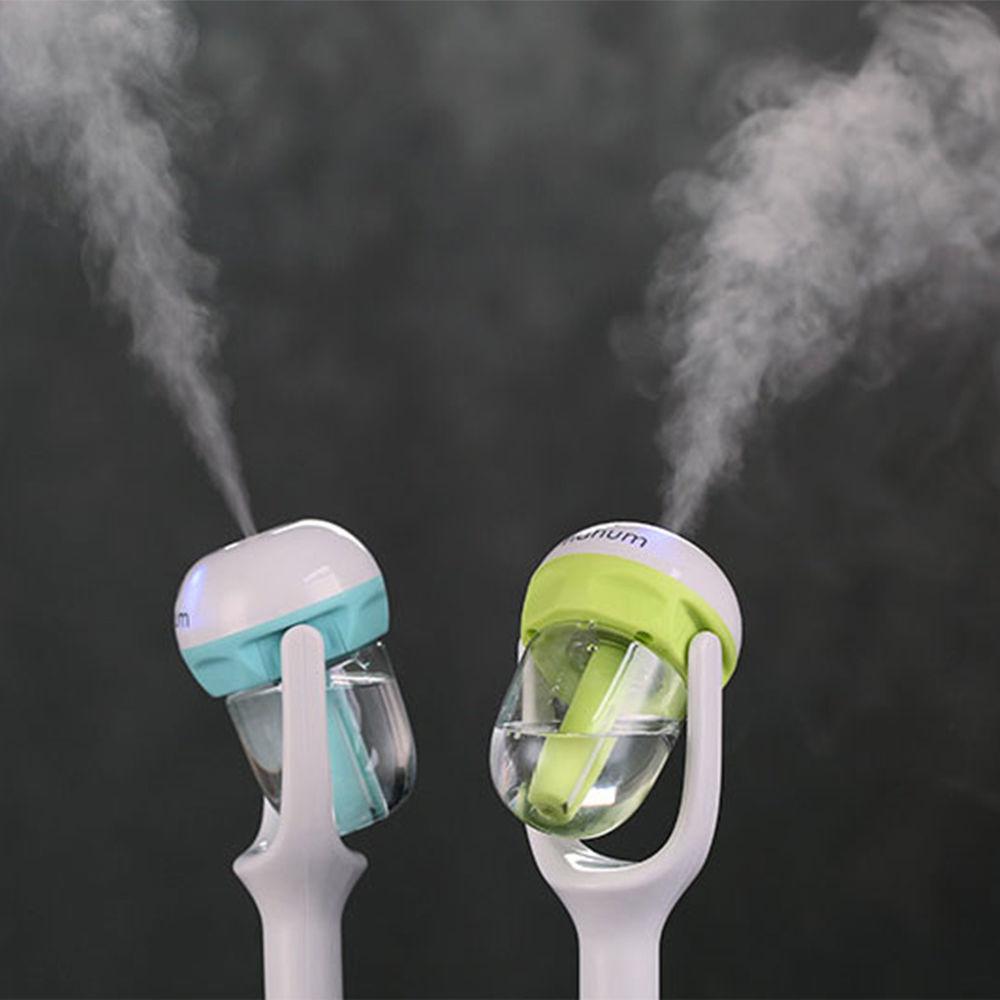 Teal and lime mini car humidifier diffusers showing mist output from clear tanks