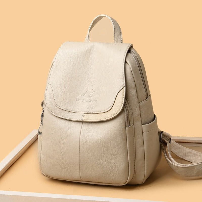 Off-white faux-leather backpack with front flap pocket, side zippers, and shoulder strap