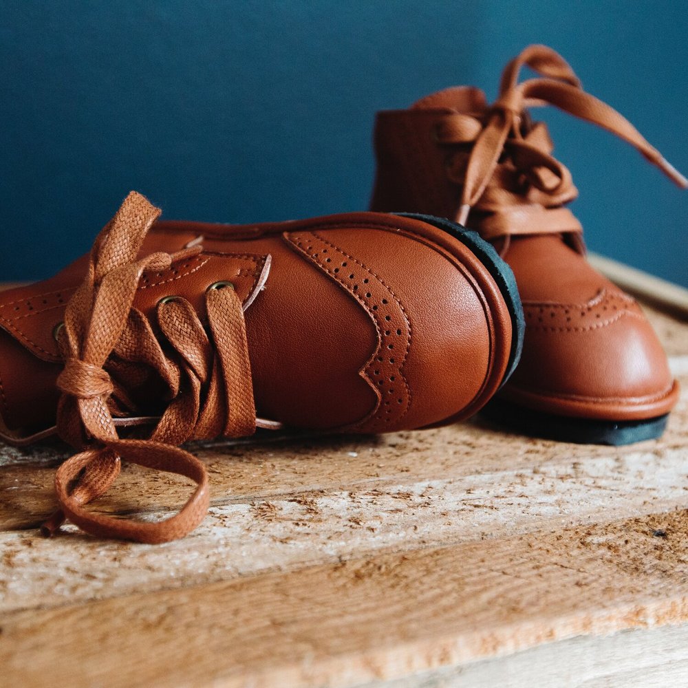 Chestnut kids lace-up boots, side view, stitched panels and flexible sole