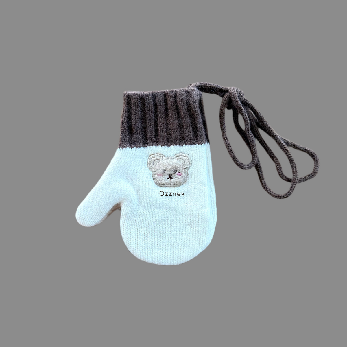 Kids winter mittens with light blue knit, dark ribbed cuffs, and bear patch on palm