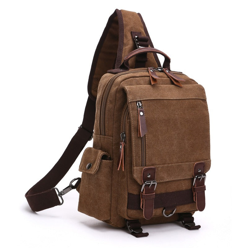Brown canvas backpack with top handle, front flap pocket, and adjustable shoulder strap