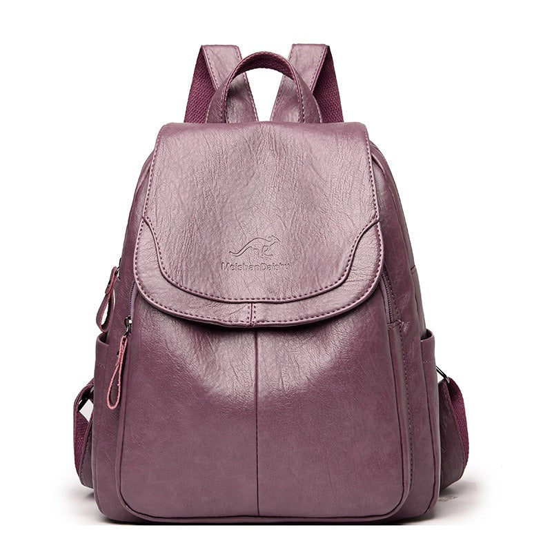 Women’s burgundy backpack with front flap pocket, top handle, and side zipper details