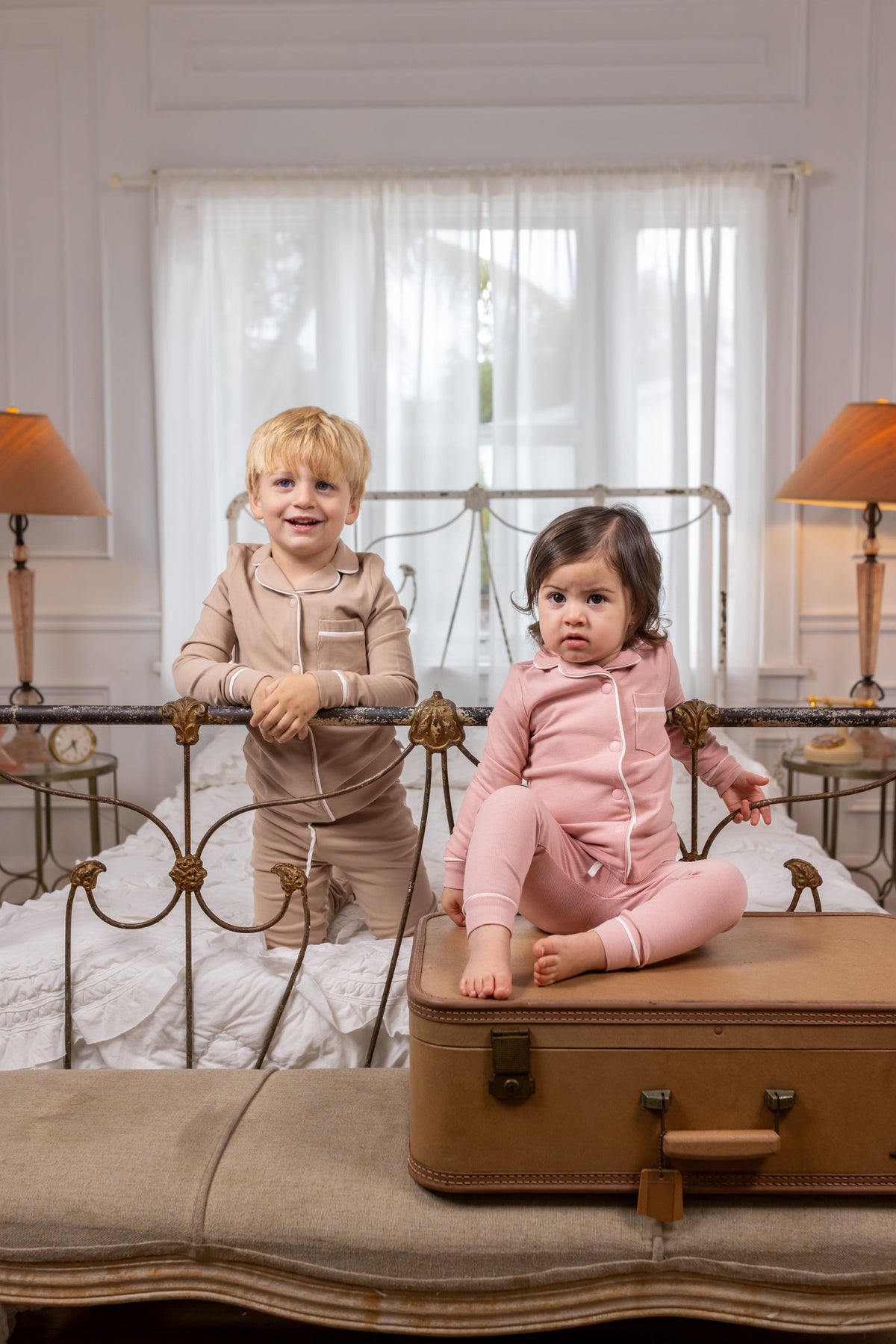 Pink long-sleeve pajama sets with contrast piping on two children