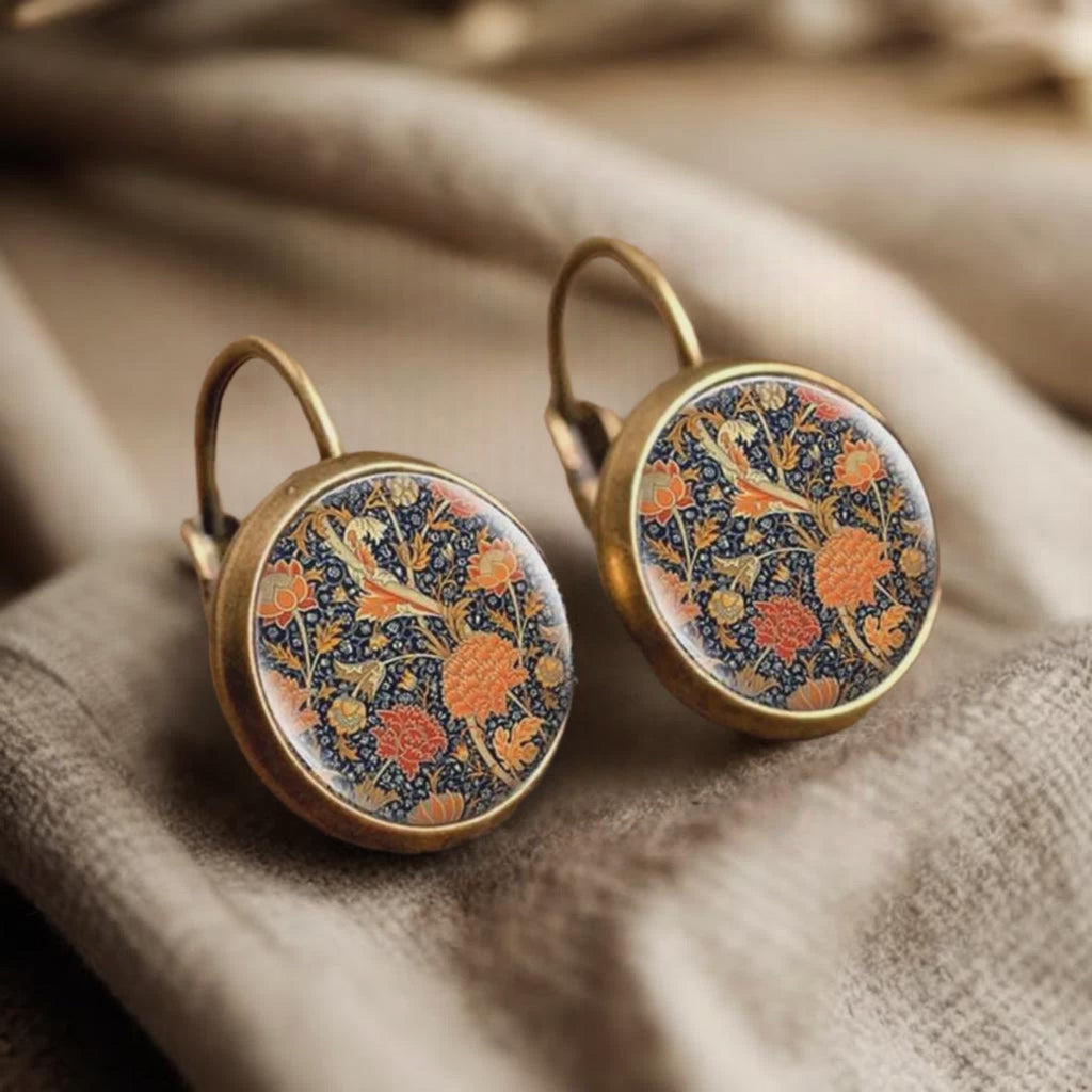 Round floral earrings with orange and blue pattern, bronze leverback hooks.