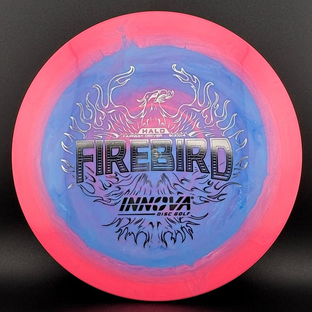 Disc golf driver with pink rim and blue center, fiery “Firebird” graphic
