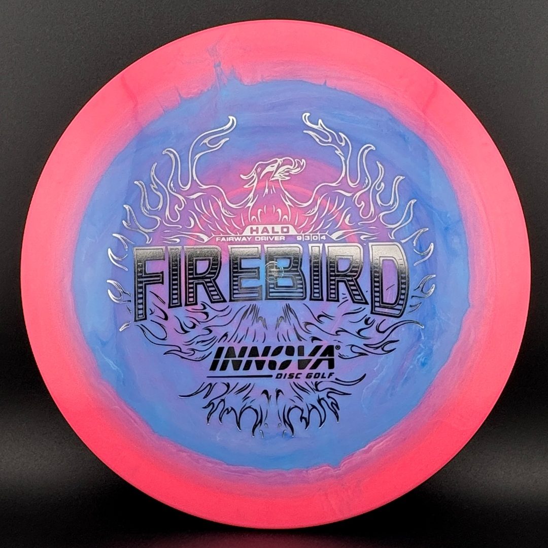 Disc golf driver with pink rim and blue center, fiery “Firebird” graphic