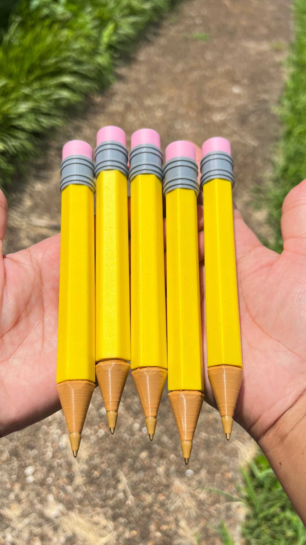Jumbo novelty pencils (5) fan-out: yellow bodies, pink erasers, gray striped bands, wood tips