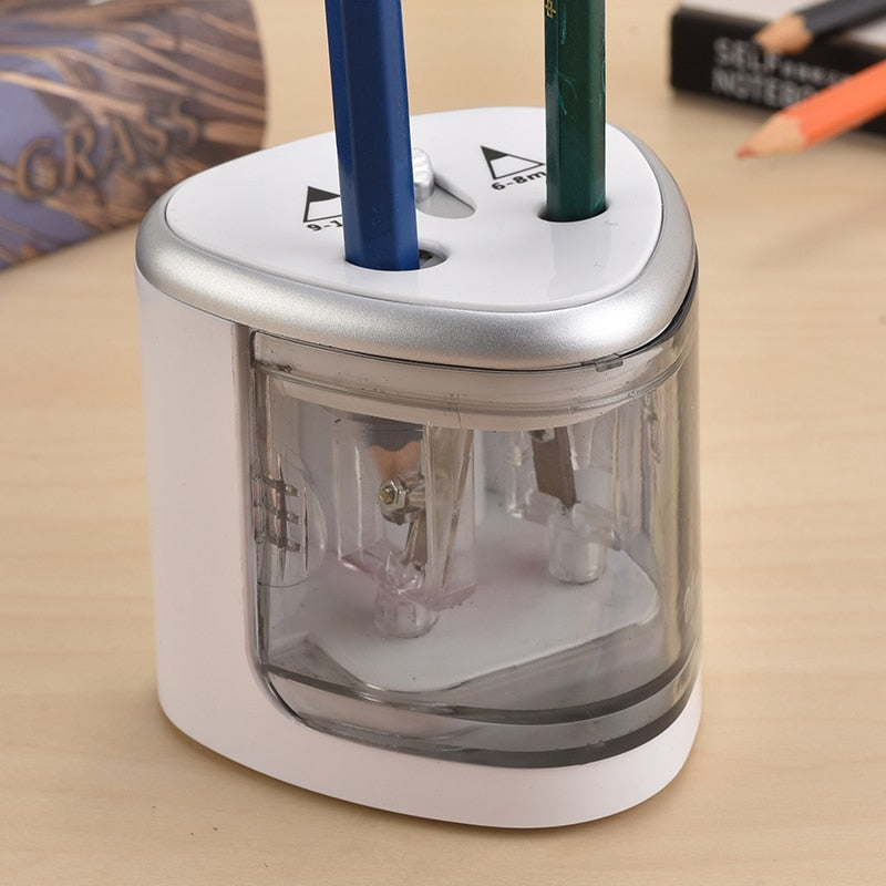 White two-hole electric pencil sharpener with clear chamber and two pencil slots