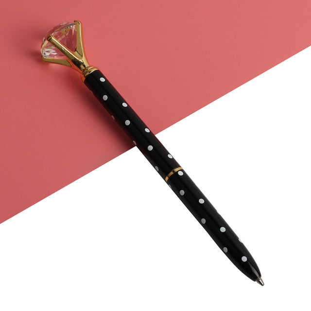 Kawaii ballpoint pen with black barrel and white dot pattern, gold gem-style cap