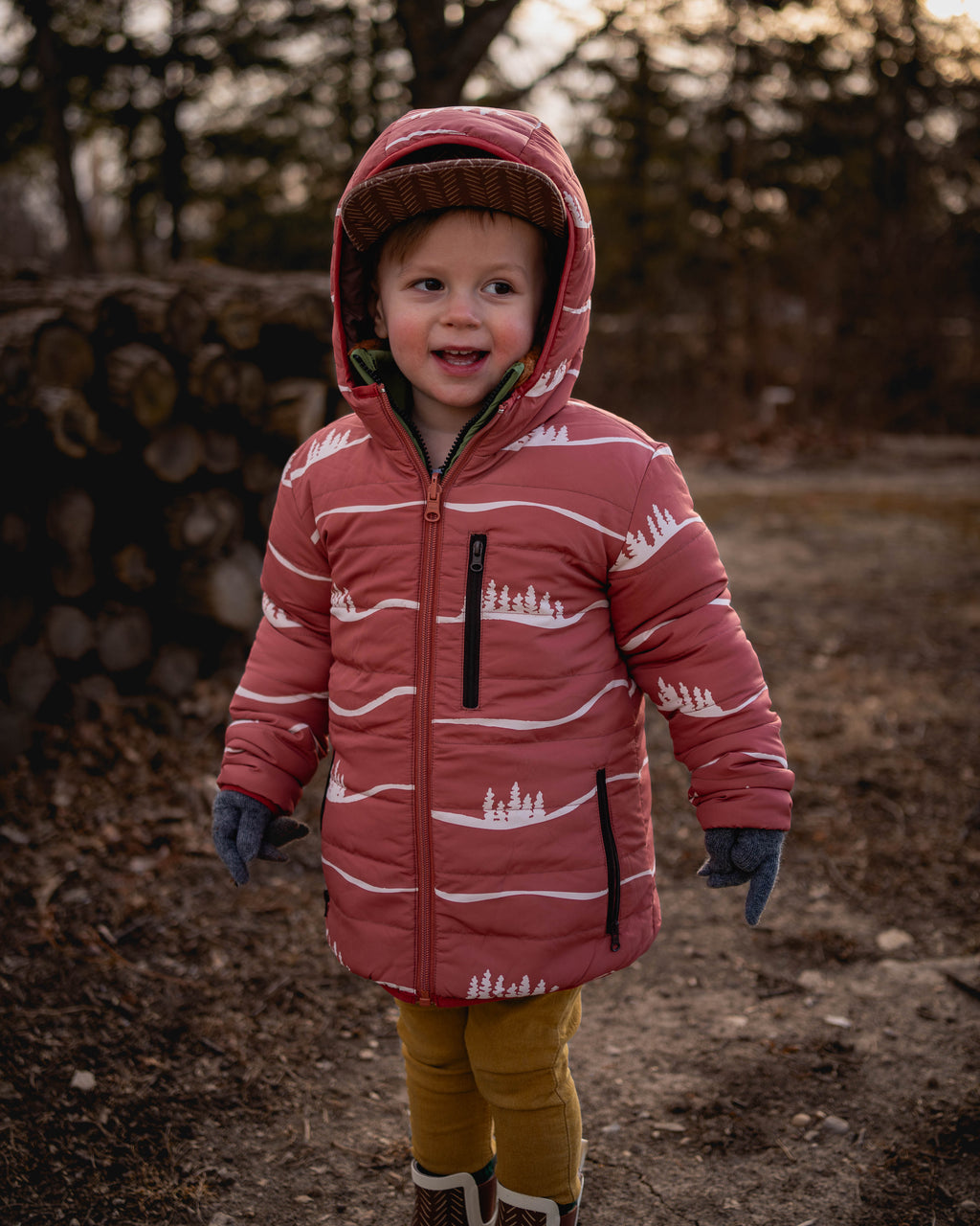 Kids reversible puffy jacket with maroon hood, front zipper, and white stripe design