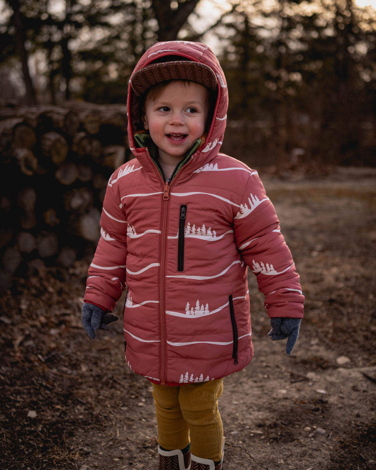 Kids reversible puffy jacket with maroon hood, front zipper, and white stripe design